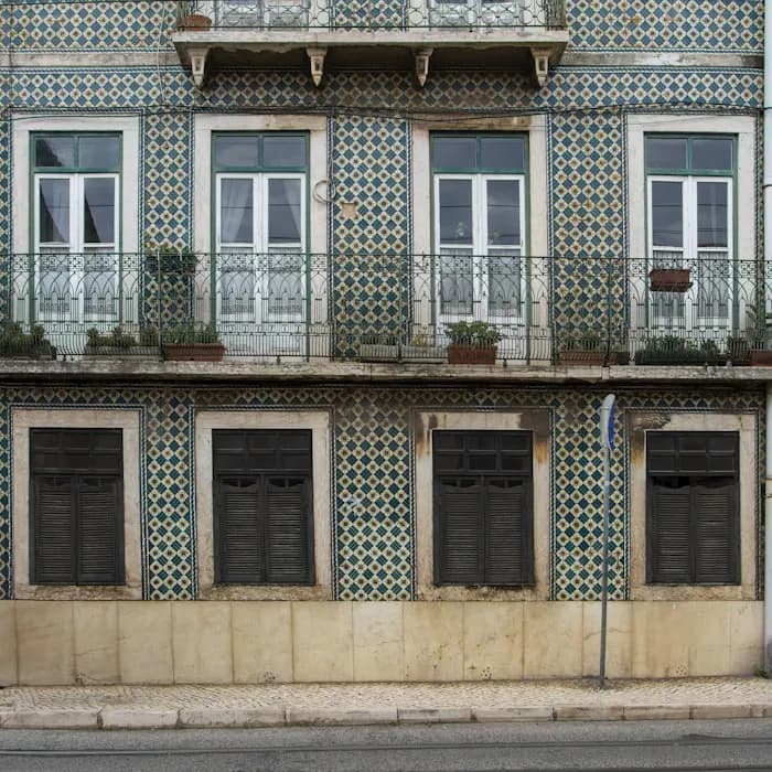 A Lisbon facade of patterned azulejo tiles and wrought-iron balconies
